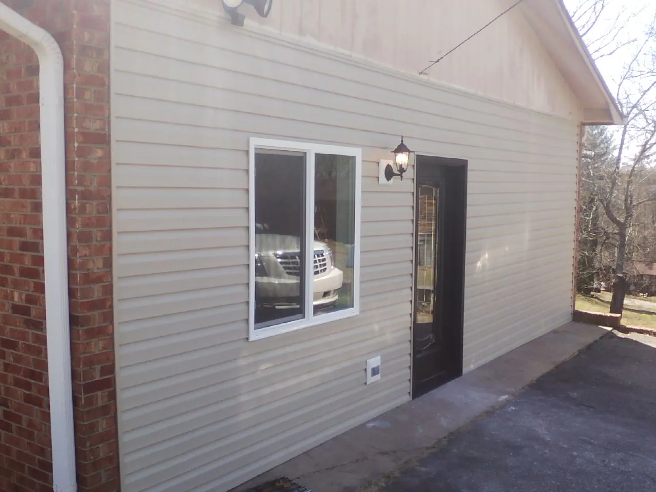 New vinyl siding and entry door on a room addition in Cardiff By The Sea