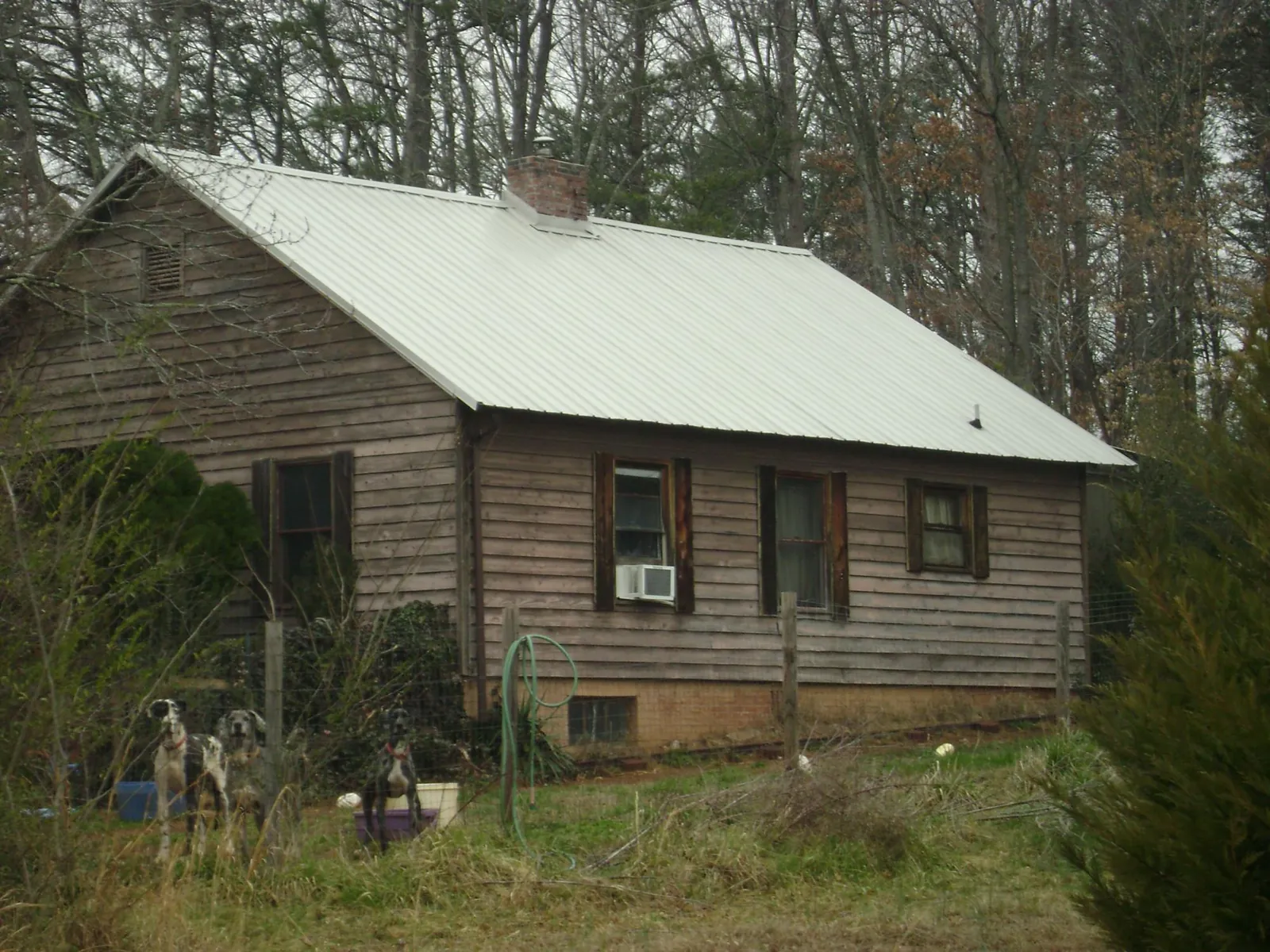 White metal roof on an old wood sided farmhouse, from a Metal Roof Installation job in Cardiff By The Sea